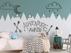 a child's bedroom decorated in black and white with an adventure await wall decal