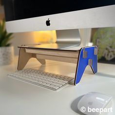 an apple computer sitting on top of a white desk next to a keyboard and mouse