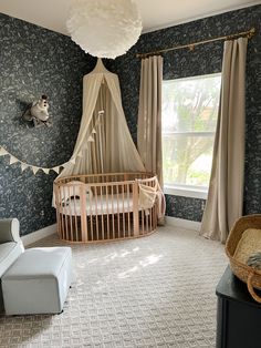 a baby's room with a crib, rocking chair and large window in the corner