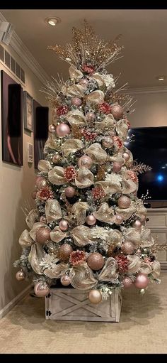 a decorated christmas tree in a living room with ornaments on the top and bottom half