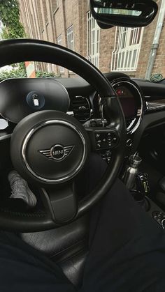 the interior of a car with black cloths and steering wheel covers on it's dashboard