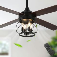 a ceiling fan with three light bulbs hanging from it's blades and a remote control