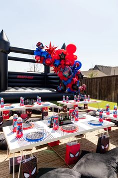 an inflatable spiderman balloon is set up on a table for a birthday party