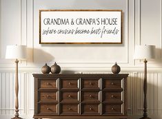 a sign that says grandma and grandpa's house on the wall above a dresser