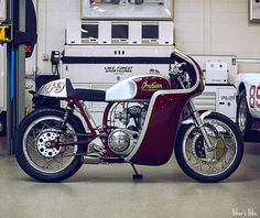 a red and white motorcycle parked in a garage