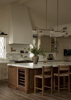 a large kitchen with an island in the middle