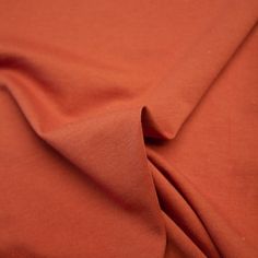 an orange colored fabric with very thin lines