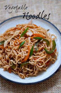 a white plate topped with noodles and veggies