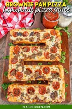 sausage and tomato flatbreads on a wooden cutting board