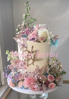 there is a cake with flowers on the top and letters on the bottom that say happy birthday