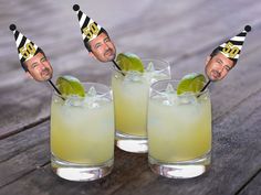 two glasses filled with lemonade and limes, one has a man's head sticking out of the top