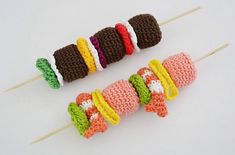 crocheted food on skewers sitting next to each other