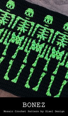 a crocheted afghan with the words bonez written in neon green on it