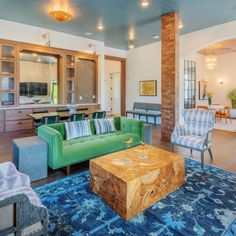 a living room filled with furniture and a blue rug