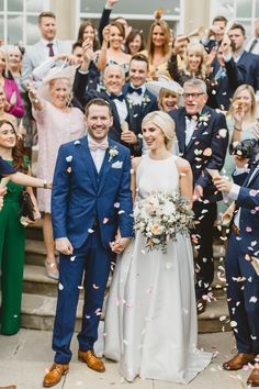 a bride and groom are surrounded by confetti