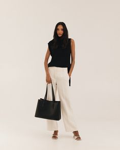 Polished work bag, meet casual weekend tote. Designed from the inside-out with a thoughtful system of interior pockets and card slots, and handcrafted in our supple, soft-yet-structured vegan ultrafiber leather. Fits 13-14” laptops (measured diagonally) with ease, and center divider means you can even carry two safely. Features a structured base that keeps the bag standing upright even when full, comfortable 2cm wide straps that won't dig into your shoulder, and a handy key leash to keep your ke Brushed Brass Hardware, Leather Fits, Work Tote, Black Luxury, Pack Your Bags, Casual Weekend, Weekender Tote, Work Bag, Black Tote