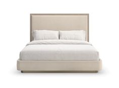 the bed is made up with white linens and pillows on it's headboard