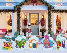 christmas decorations in front of a house decorated for the holidays