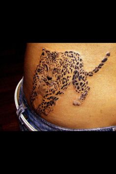 a woman's stomach with a tattoo of a cheetah