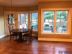 a dining room with hard wood floors and windows