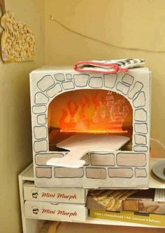 an oven that is sitting on top of a table next to some books and other items