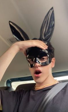 a person wearing a mask and bunny ears