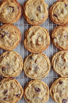 chocolate chip cookies on a cooling rack with cranberry toppings in the middle