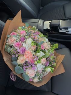 a bouquet of flowers sitting in the back seat of a car