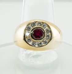 Mens Ring, Natural Diamond Ring, Genuine Ruby Ring, 14K Gold Band, Natural Diamond Band, Natural Ruby Band, July Birthstone. This gorgeous estate ring for a gentleman is finely crafted in solid 14K Yellow Gold. The center genuine Earth mined round cut Ruby measures 4.2 mm (.36 carat). This is a very clean and transparent gem of great intensity and strong brilliance. Eleven white and fiery round brilliant cut diamonds total .88 carat of VS2 clarity and G color. The top of the ring measures 14 mm Classic Ruby Ring With 17 Jewels, Classic Round Signet Ring With Center Stone, Gold Byzantine Ruby Ring, Mens Real Ruby Rings, Luxury Polished Men's Ruby Ring, Luxury Handmade Ruby Ring For Men, Luxury Polished Finish Men's Ruby Ring, Estate Ring, Ruby Bands