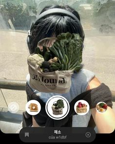 a person holding up a bag full of vegetables and other food in front of their face