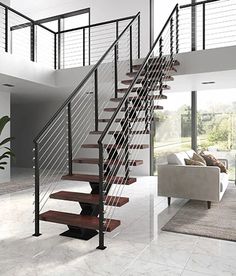 a living room filled with furniture and a stair case