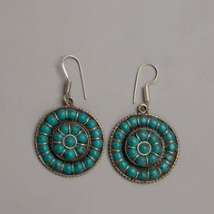 Turquoise Blue Earrings About The Earing: With our excellent Turquoise Blue Earrings, which are painstakingly created on white metal with silver plating and showcase the captivating attraction of turquoise gemstones, you may embrace the alluring beauty of turquoise. These earrings, which are 6 cm in length, are a classy and striking accent to any outfit. Set to the brilliant background of silver plating, each earring showcases turquoise stones, which are highly regarded for their stunning blue t Turquoise Round Beads Earrings For Gift, Traditional Turquoise Metal Earrings, Vintage Turquoise Round Earrings, Tibetan Earrings, Ethnic Tibetan Turquoises Earrings, Gem Earrings, Bleu Turquoise, Spiritual Gifts, Turquoise Gemstone