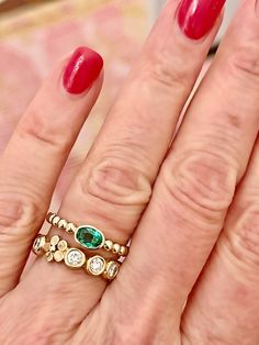 Our new beaded band ring is set with a beautiful oval 5x3 Emerald. The perfect sweet size to stack or wear every day. We set this stone in a sold gold bezel with an open bottom that allows the light to come in. There's a sizing bar at the bottom that allow us to make easy changes to the size without ruining the integrity of the beads. You'll love this new ring! 14K yellow gold 5x3 Oval Emerald Ring sizes 5-8 Beaded band design Classic Oval Stackable Emerald Ring, Oval Bezel Set Stackable Rings For Anniversary, 14k Gold Stackable Rings With Smooth Bezel, Elegant Oval Stackable Rings With Gemstone Accents, Oval Emerald Ring, Beaded Stacking Rings, Gemstone Stacking Ring, Emerald Bead, Band Design