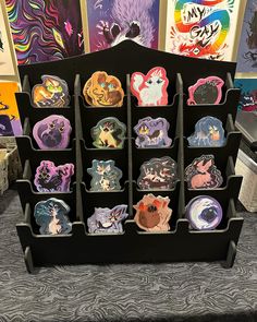 a display case filled with lots of different colored stickers on top of a table