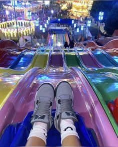 the person is sitting on top of an inflatable slide