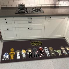 star wars characters on the floor in a kitchen with white cabinets and countertops