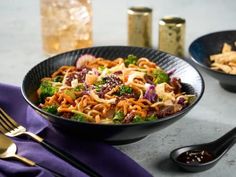 a bowl of noodles with broccoli and other foods