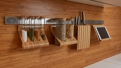 a kitchen with wooden walls and shelves filled with spices, cereals, grains and other items