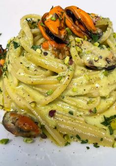 pasta with vegetables and sauce on a white plate