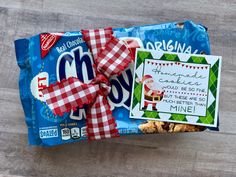 a candy bar wrapped in red and white checkered ribbon with a christmas message on it