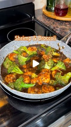 shrimp and broccoli cooking in a skillet on the stove with words saying shrimp & broccoli