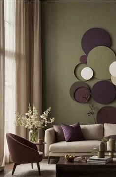 a living room filled with furniture and lots of purple decorations on the wall above it