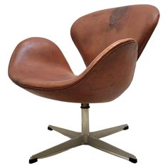 an egg chair is shown in brown leather