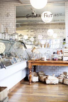 the inside of a bakery with bread and pastries on display