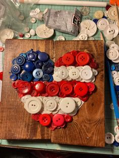 a wooden cutting board topped with lots of buttons