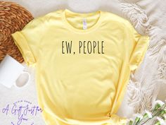 Ew People t-shirt, Funny T-Shirts, Sarcasm T-Shirt, Introvert T-Shirt, Yellow Shirt, Unisex T-Shirts, Free Shipping This is a  premium quality T-shirt  - 100% Airlume Combed and Ringspun Cotton Bella+Canvas 3001 is a Unisex t-shirt extremely soft and comfortable to wear. This is the perfect shirt for the one you love! Our T-Shirts are high quality, super soft, and comfy. Made with top-of-the-line vinyl and pressed with a professional-grade heat press.  Please be advised before your order. Thanks Italy Shirt, California Shirt, London Gifts, Minimalist Shirts, Yellow Shirt, Yoga Tshirt, Slogan Tee, Yellow T Shirt, Yellow Shirts