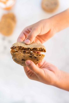 a person holding a cookie in their hand