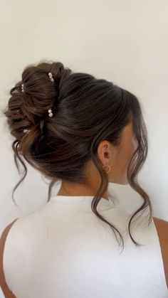 a woman with her hair in a low bun