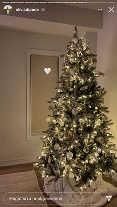 a white christmas tree with silver and gold ornaments