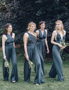 four beautiful women in long dresses posing for the camera